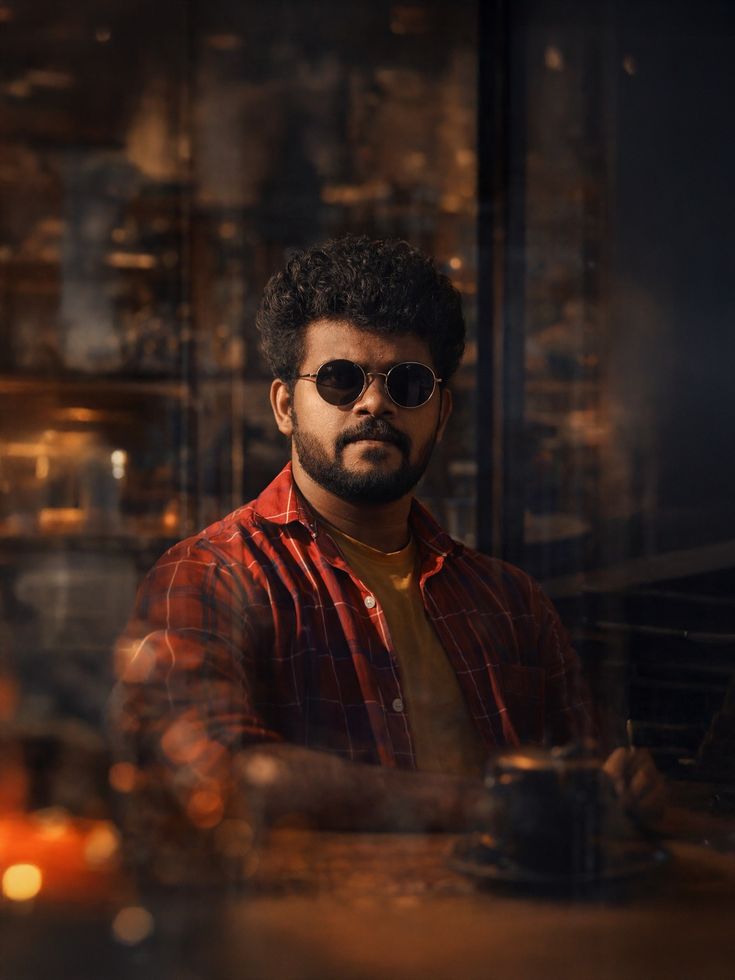Cafe Portrait Prompt for a moody cinematic café portrait with glass reflections and amber bokeh