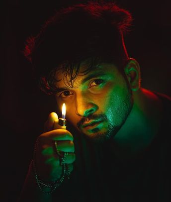 Lighter Portrait Prompt for a dramatic cinematic male portrait with flame glow and colored lighting